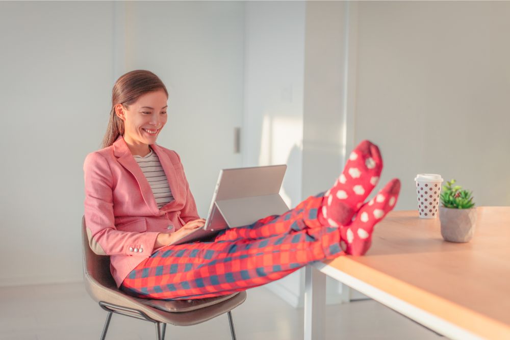 Remote interview questions: have you worked remotely in the past? Girl in pajama bottoms and work blazer on a video call